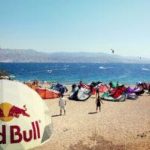 white dome tent with logotype Red Bull on beach