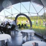 interior of dome tent while event with view at window and tables