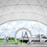 interior of white dome tent with view at window, people and car