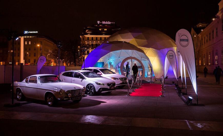 volvo cars against the backdrop of white geodesic domes