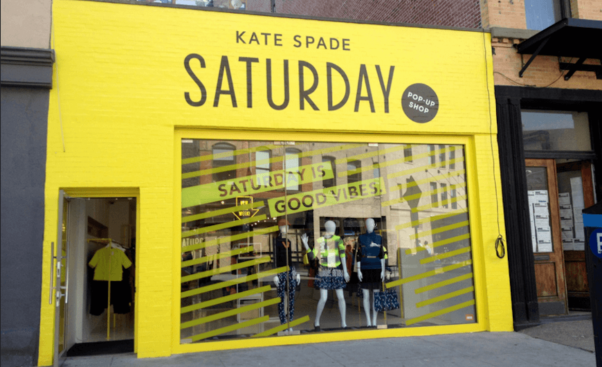 yellow storefront with text "Kate spade Saturday"
