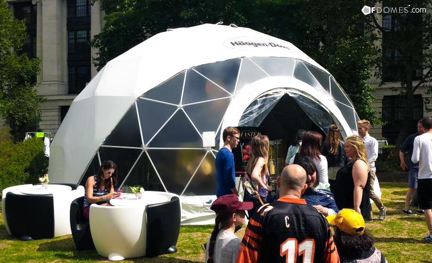a group of people in front of the geodesic dome