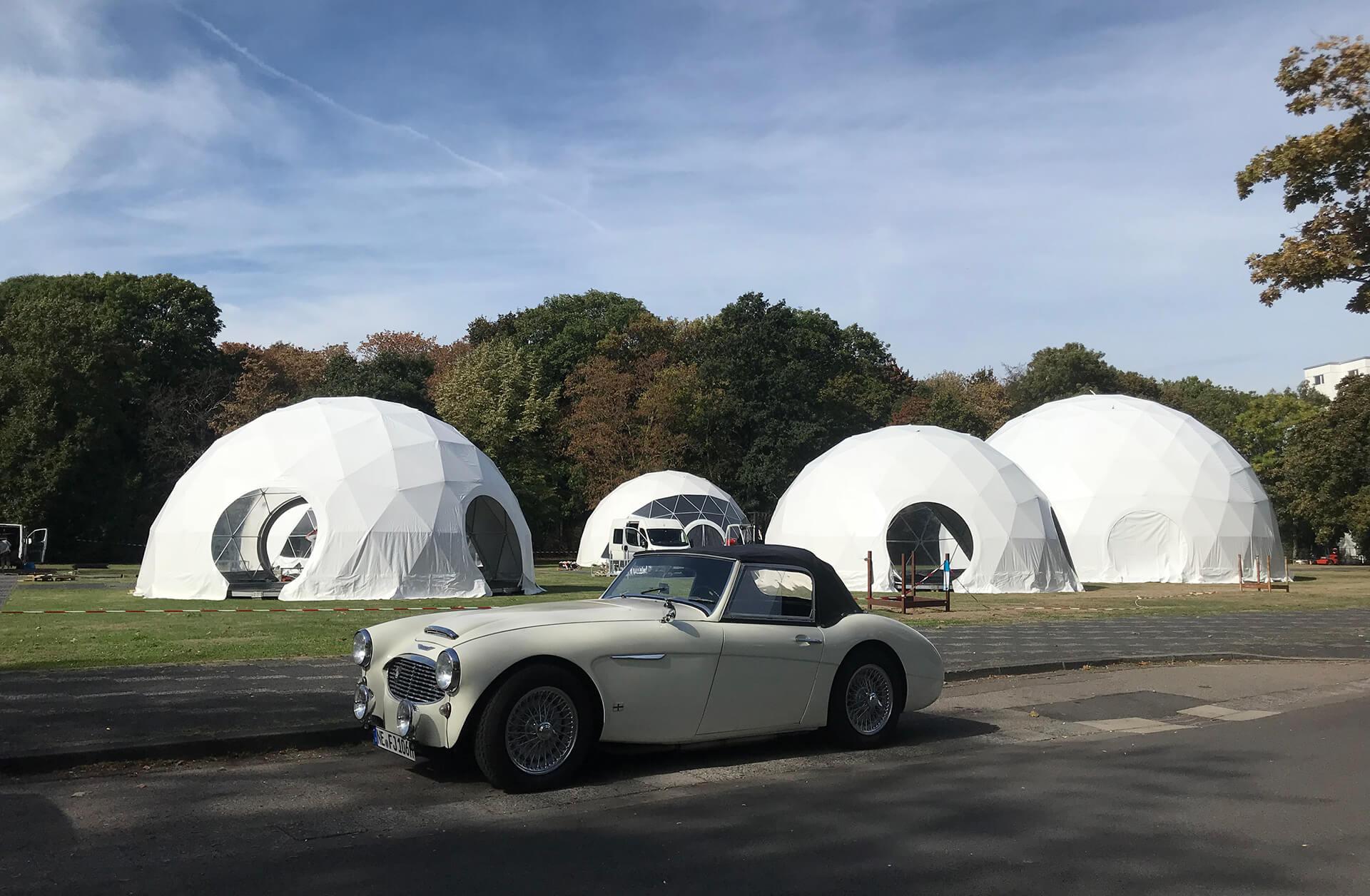classic car against the background of white geodesic domes