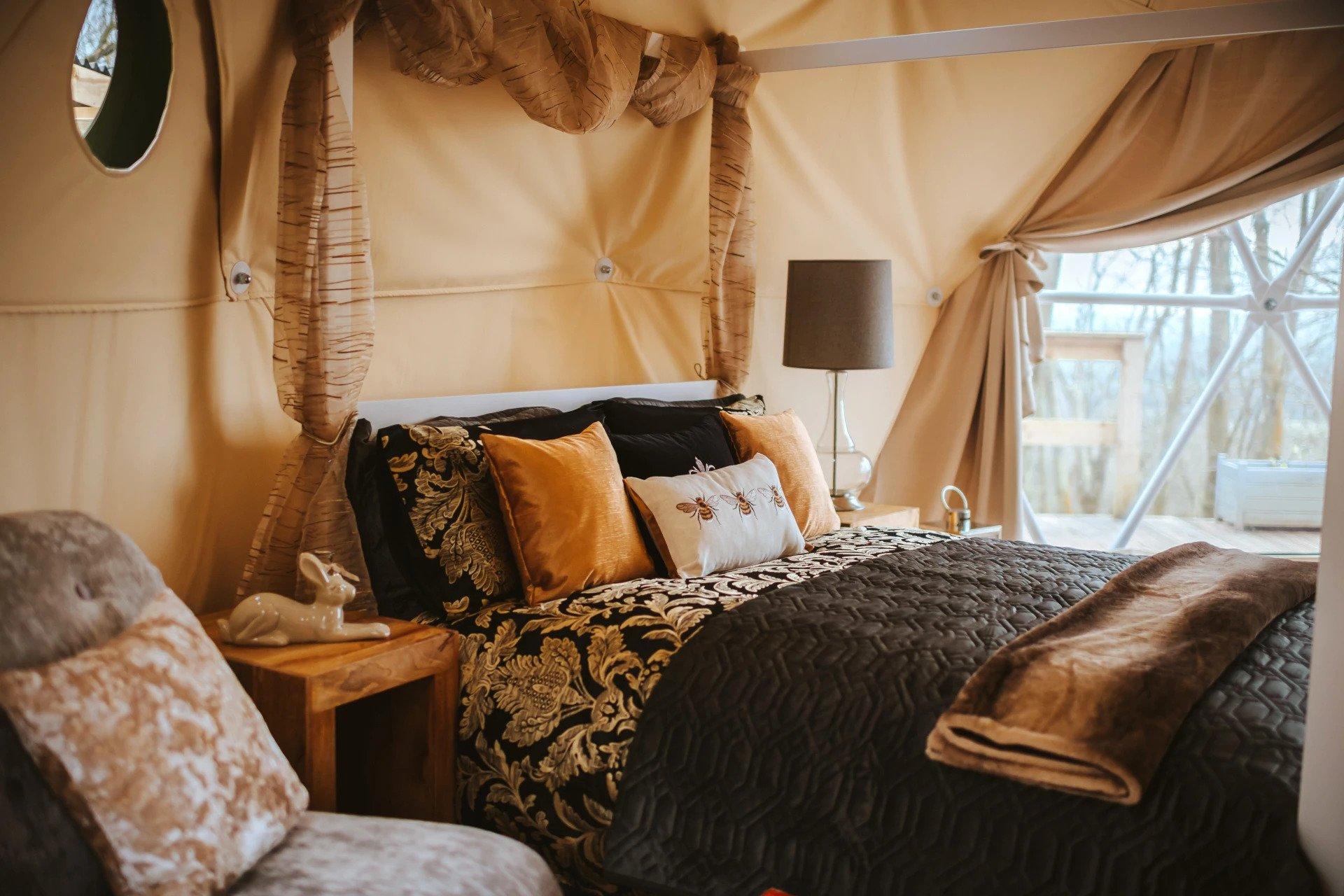 interior in rustically style of geodesic dome with view at bed, insulation and window