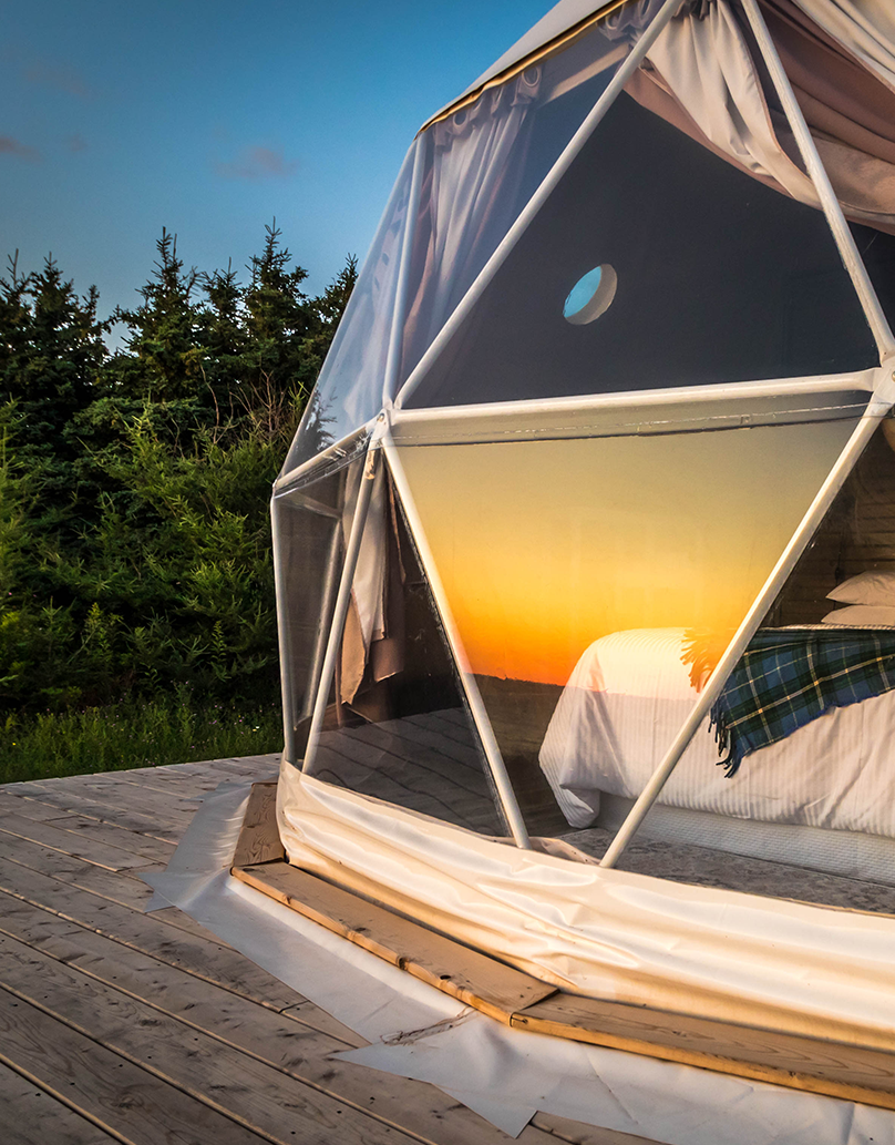Panoramic windows in the glamping geodesic dome during sunset