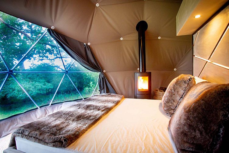 interior of geodesic dome iiwith view at window, bed, interior module, insulation and fireplace