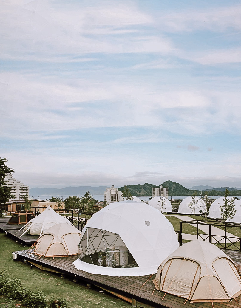 white geodesic dome between two tents