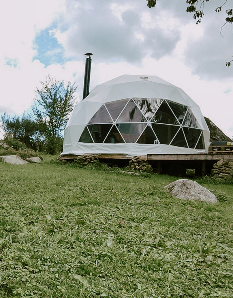 white geodesic dome with stack on the slope