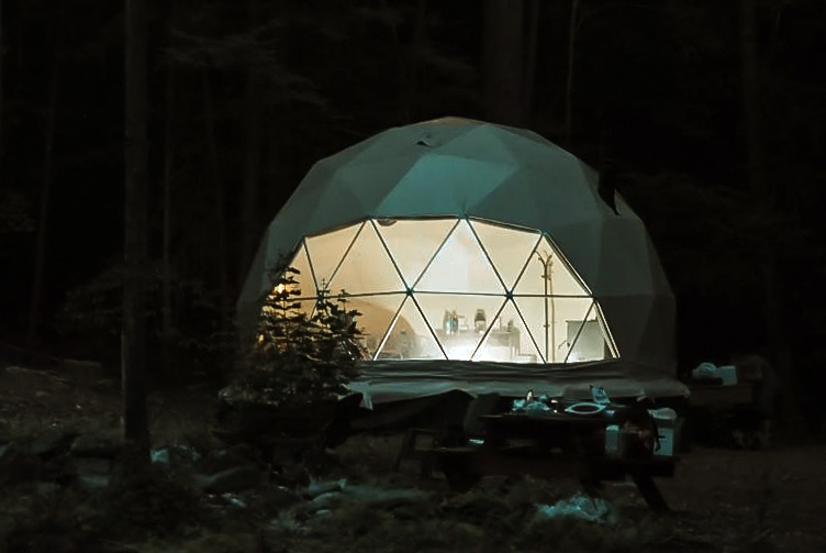 white geodesic dome in forest in night