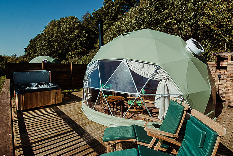green olive geodesic dome on wooden decking with jacuzzi