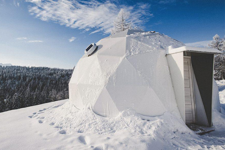 white geodesic dome in snow in mountain