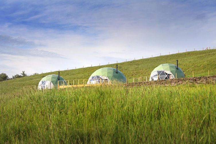 green geodesic domes at the hill
