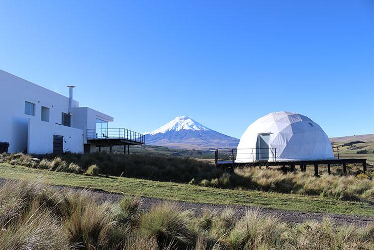 white geodesic dome against the background of a volcano