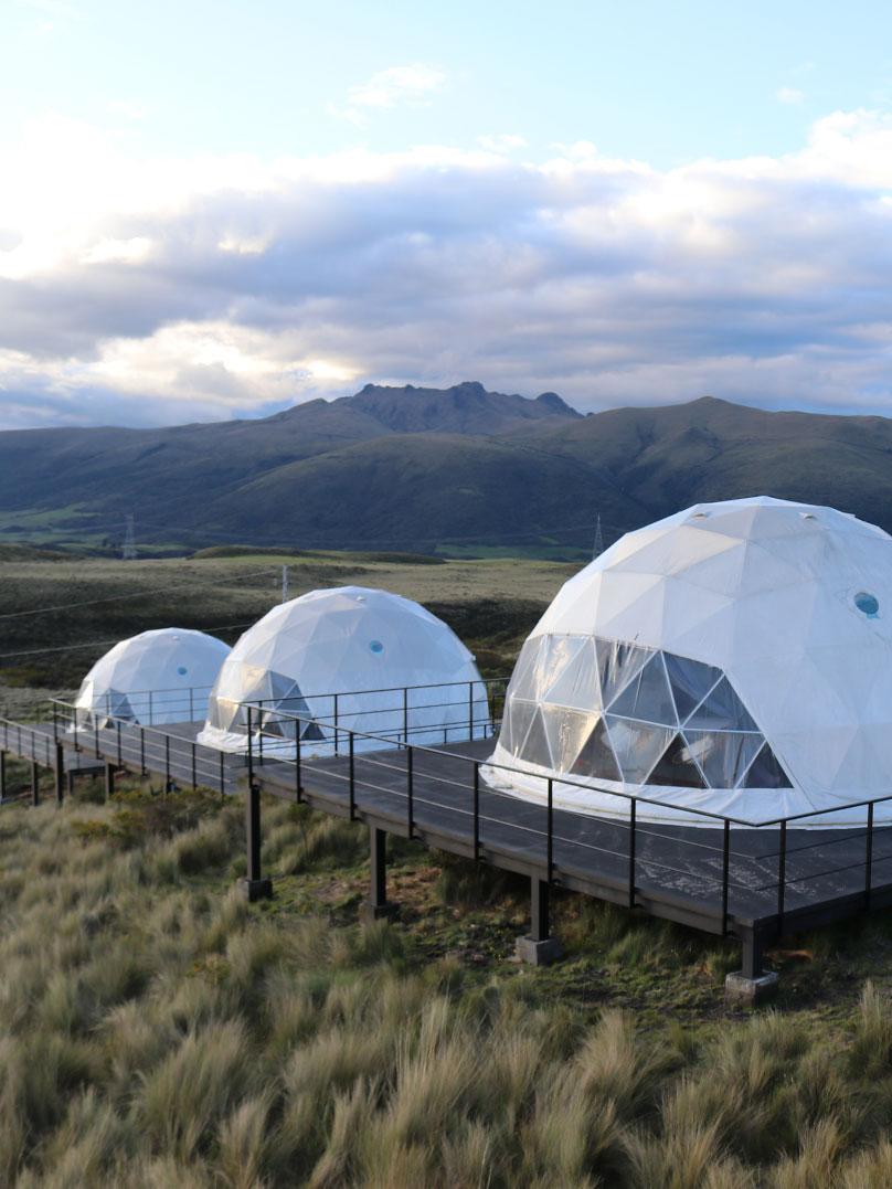 white geodesic domes against the background of mountains