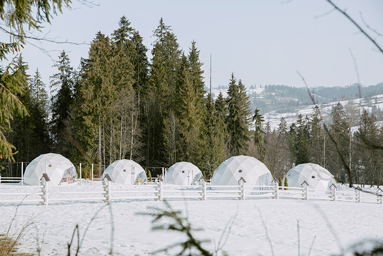 white geodesic domes in winter in mountain