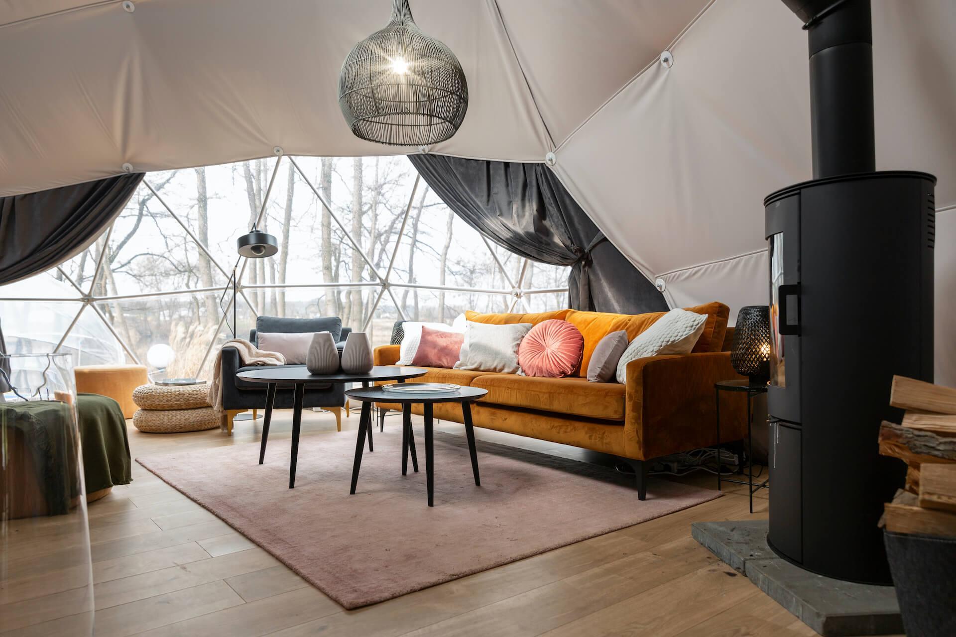 inside at geodesic dome with view on living room and wood stove