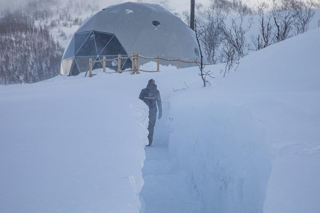 FDomes Glamping Winter Domes Person Walking in Snow Tunnel