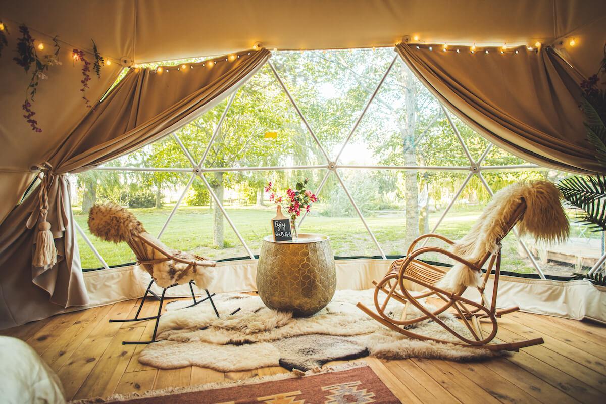Breathtaking view through panoramic bay window inviting nature surroundings inside the FDomes Glamping dome