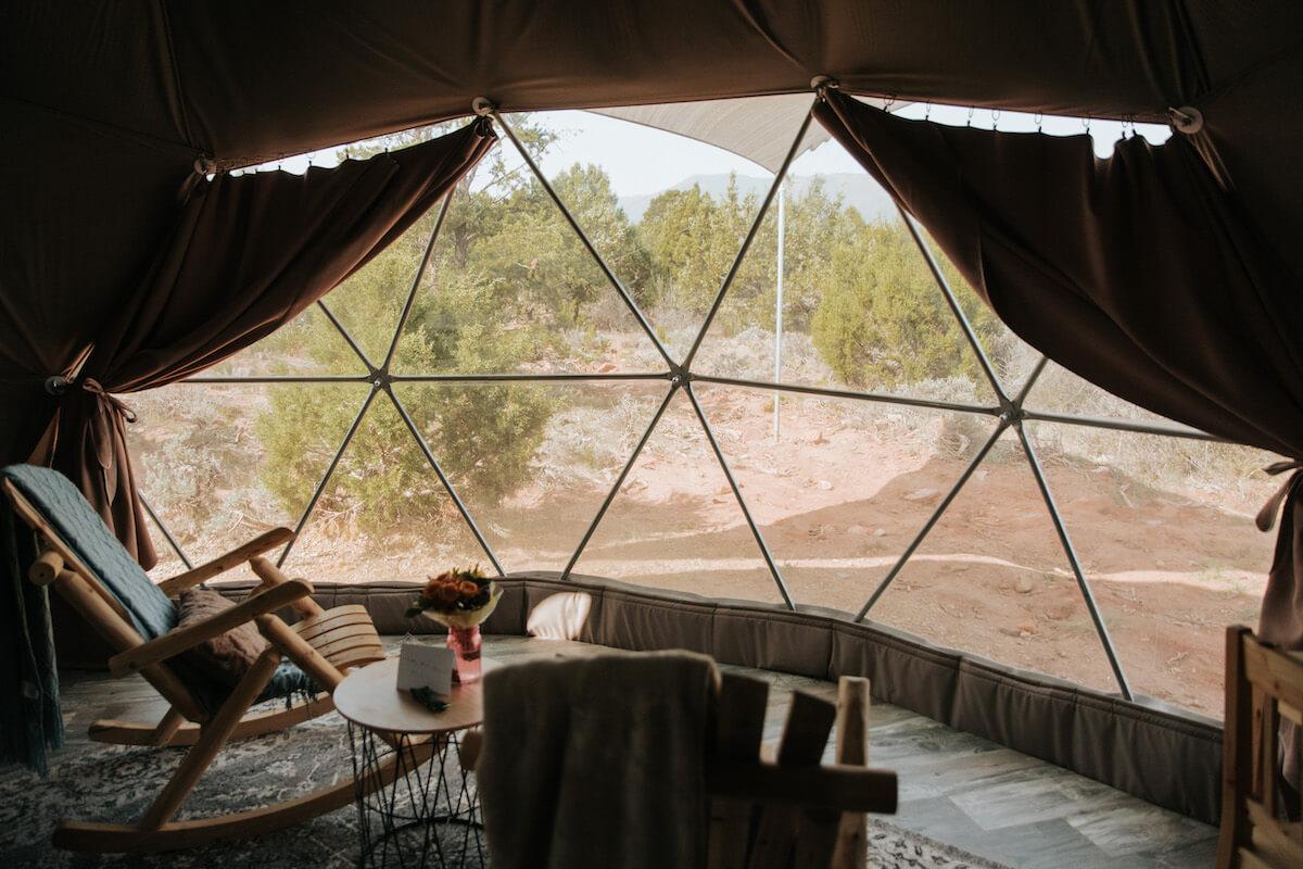 FDomes Glamping Stay At Domes resort, panoramic bay window with Curtains Kit and a rocking chair in front