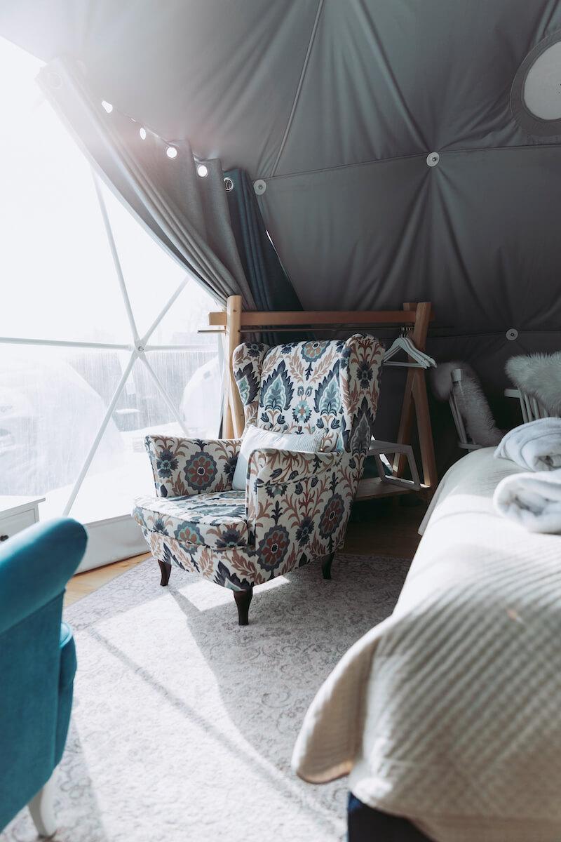 Beautiful colorful armchair inside the Tatra Glamp's dome. Bold accents in monotone interior adds the uniqueness and character to the place