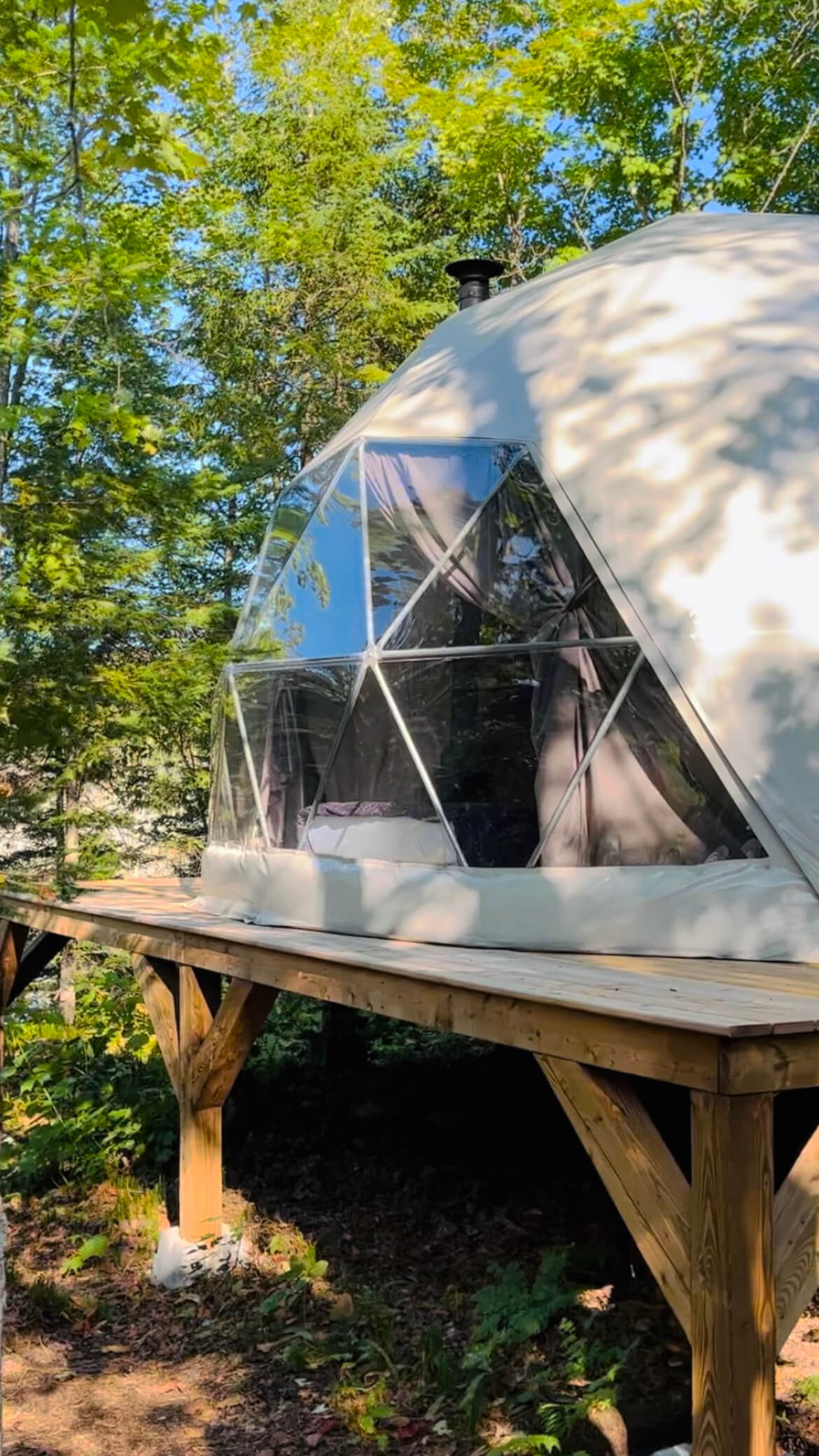 white geodesic dome on wooden deck