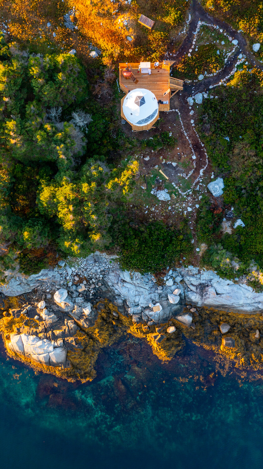 view from drone of one white geodesic dome on the island