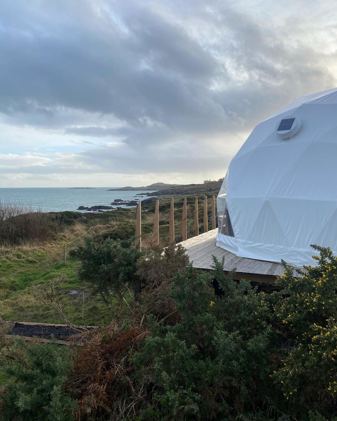 white geodesic dome on wooden deck on the hill