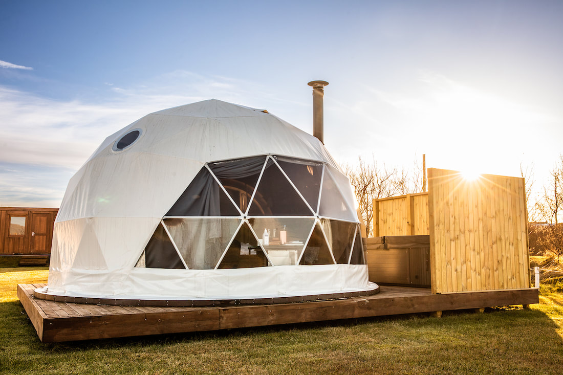 white geodesic dome on wooden deck