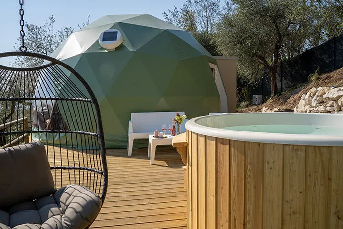 green geodesic dome on wooden deck and a jacuzzi on terrace