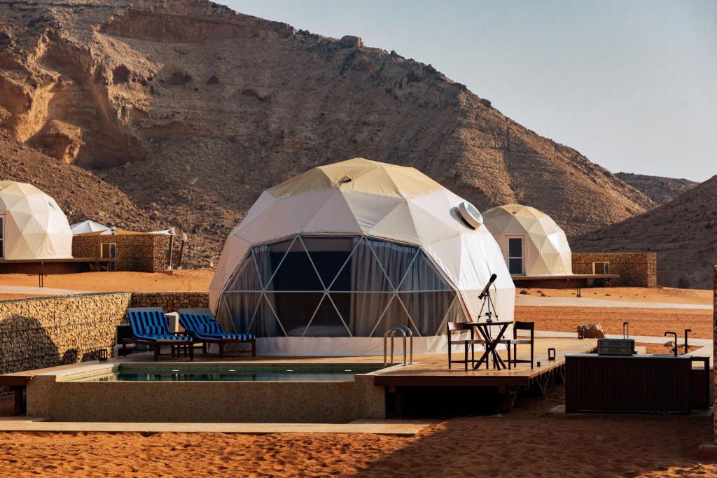 three white geodesic domes on the desert