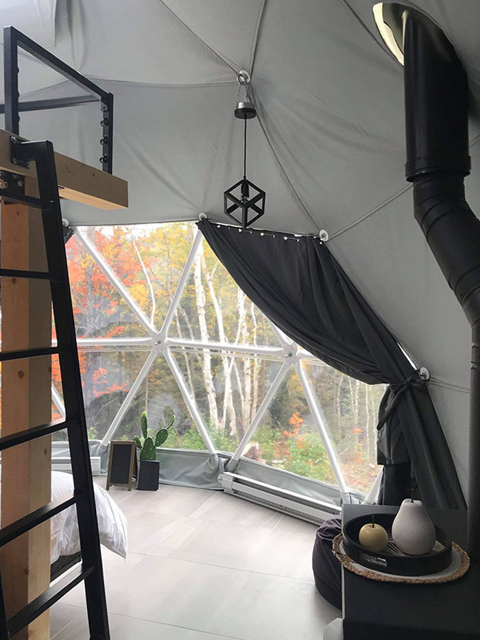 inside of geodesic dome with an internal module with ladder and a window