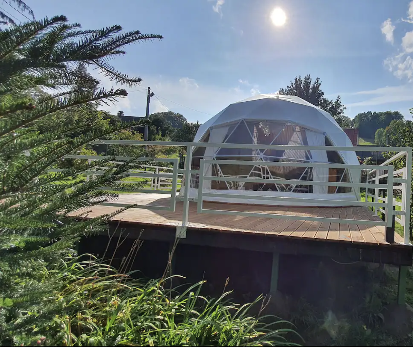white geodesic dome on wooden deck in the garden