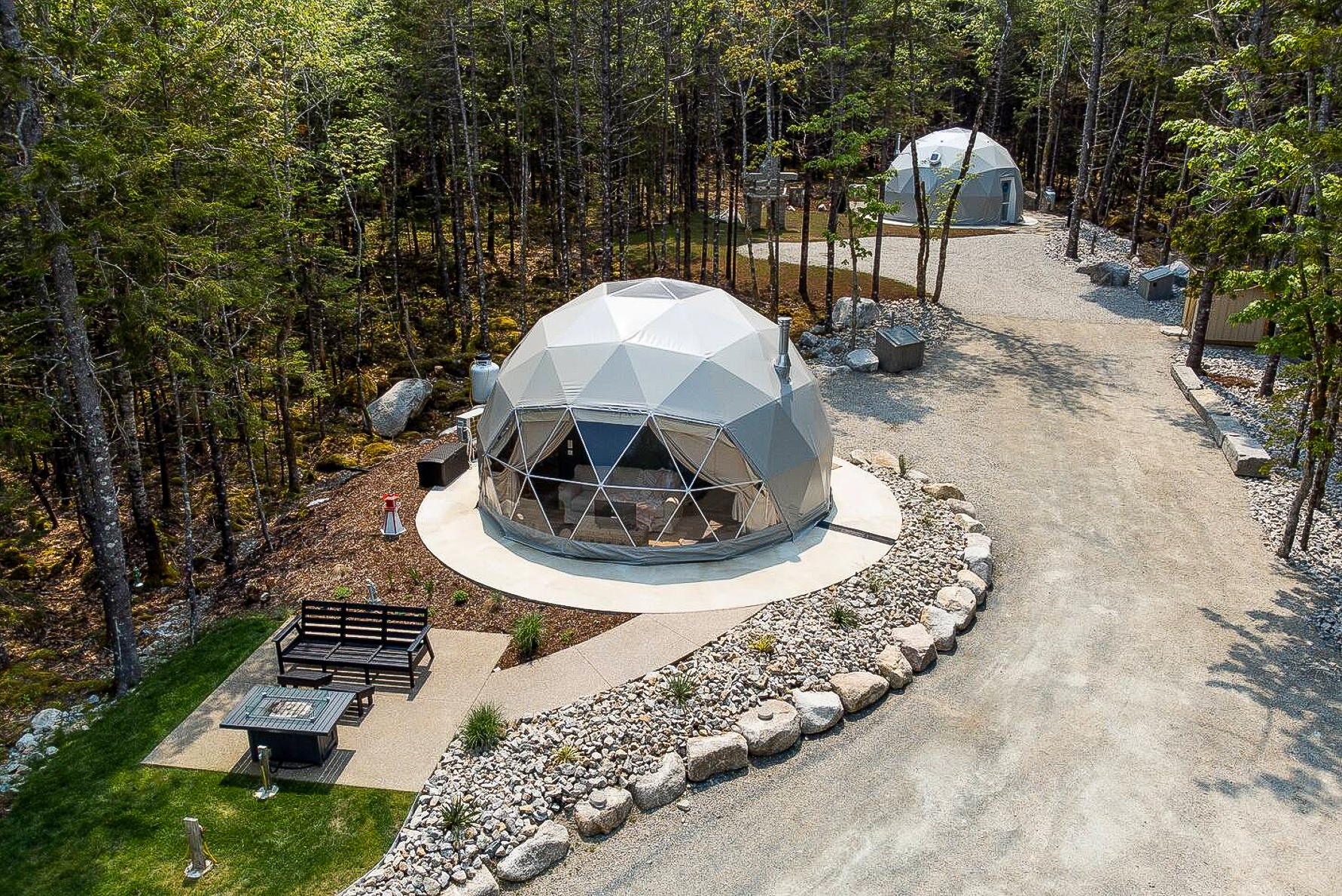 two geodesic domes on the campsite in forest