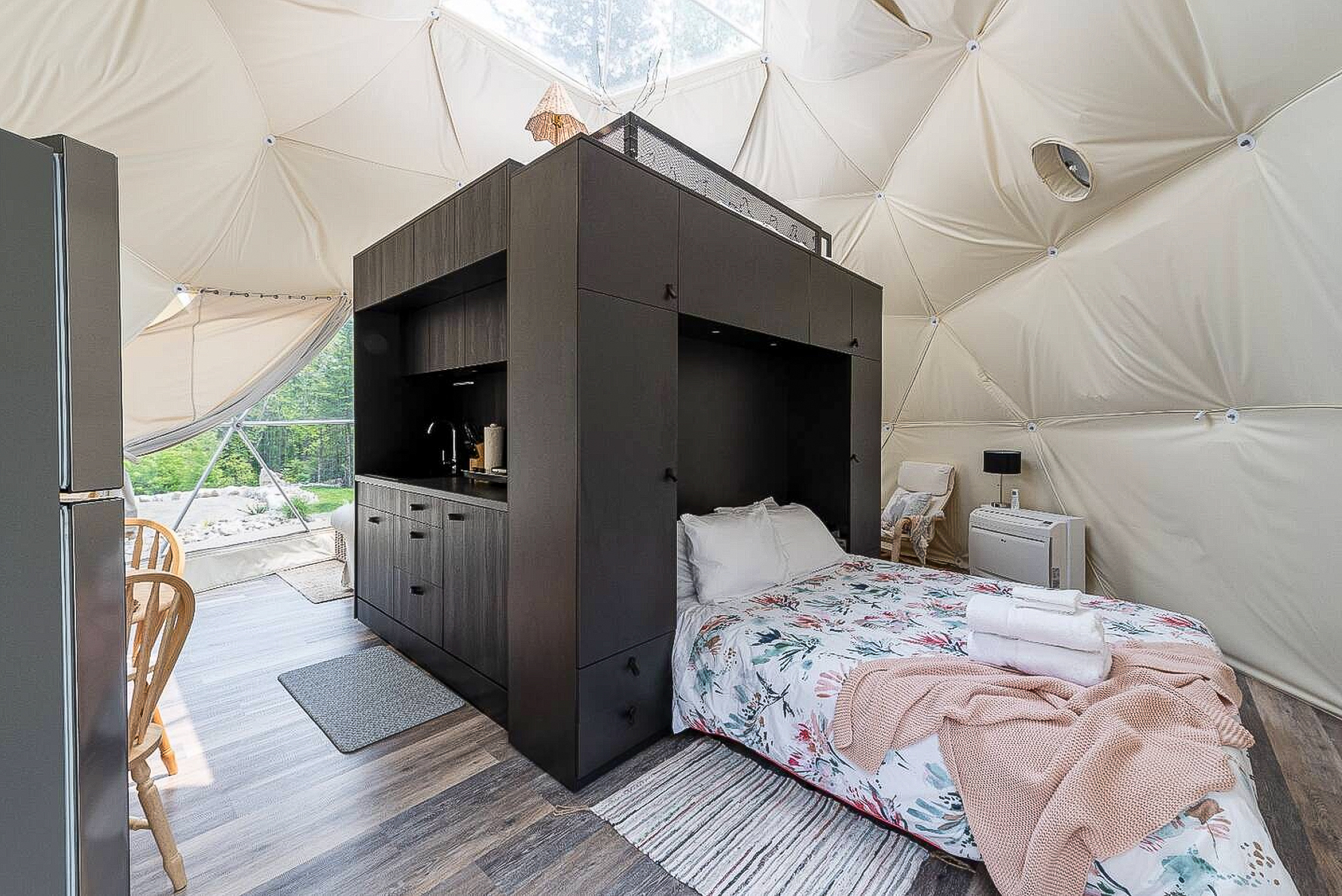 inside of geodesic dome with a interior module kitchen, interior module bedroom and a bed