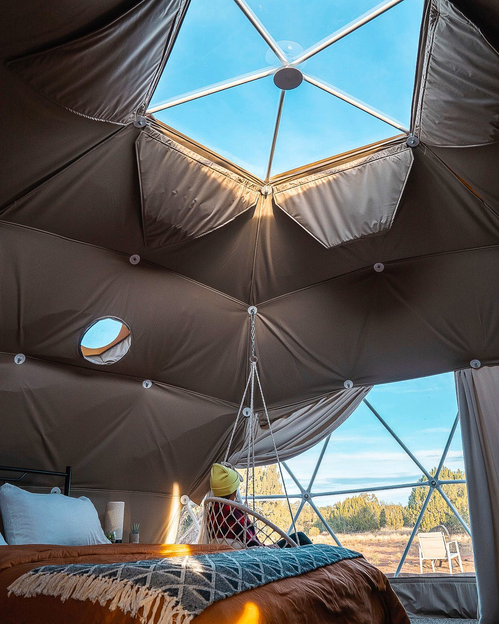 woman sitting inside of geodesic dome