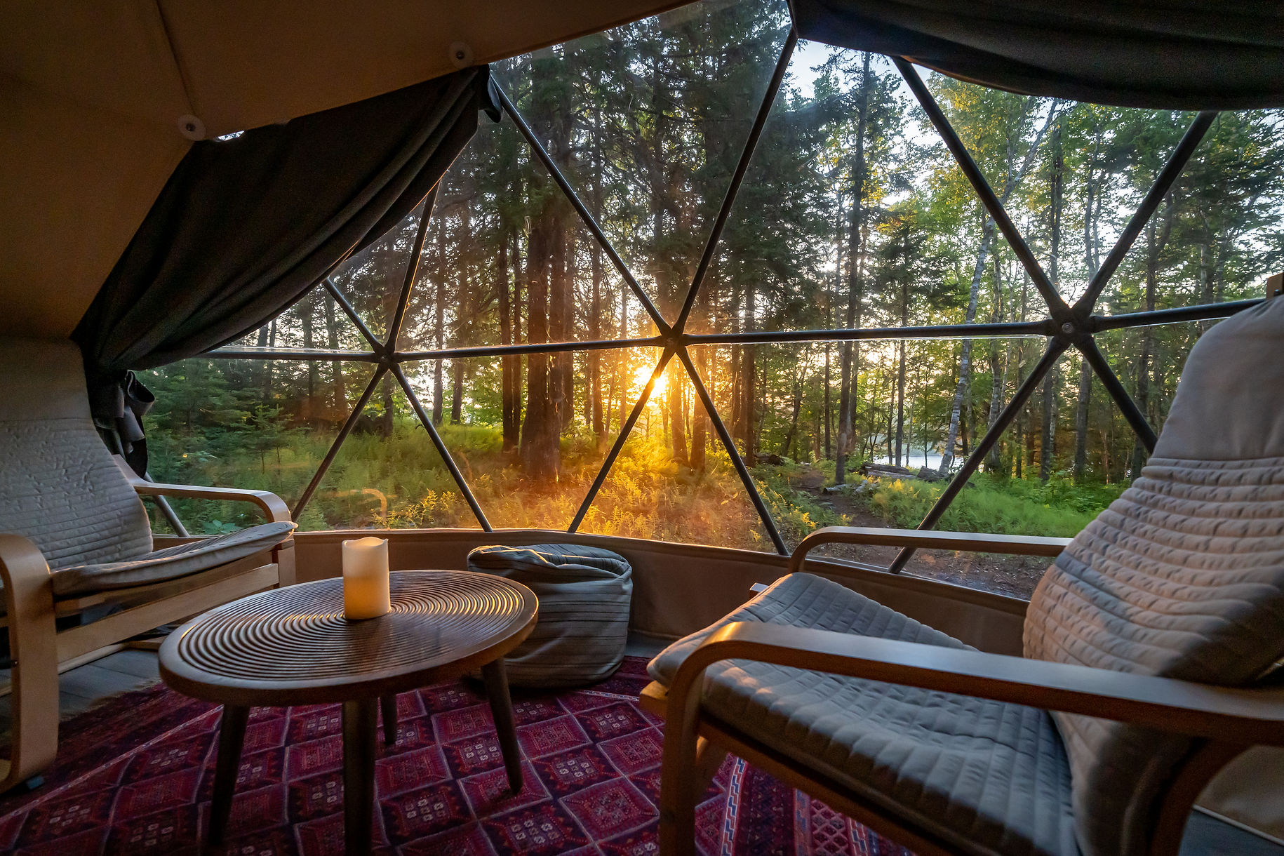 inside of geodesic dome with two armchairs and windows