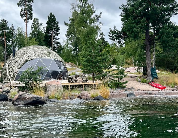 masked geodesic dome near coast of the lake
