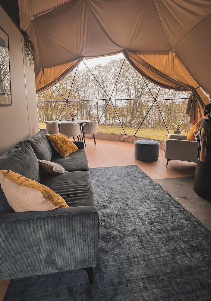 inside of geodesic dome with furniture and a view
