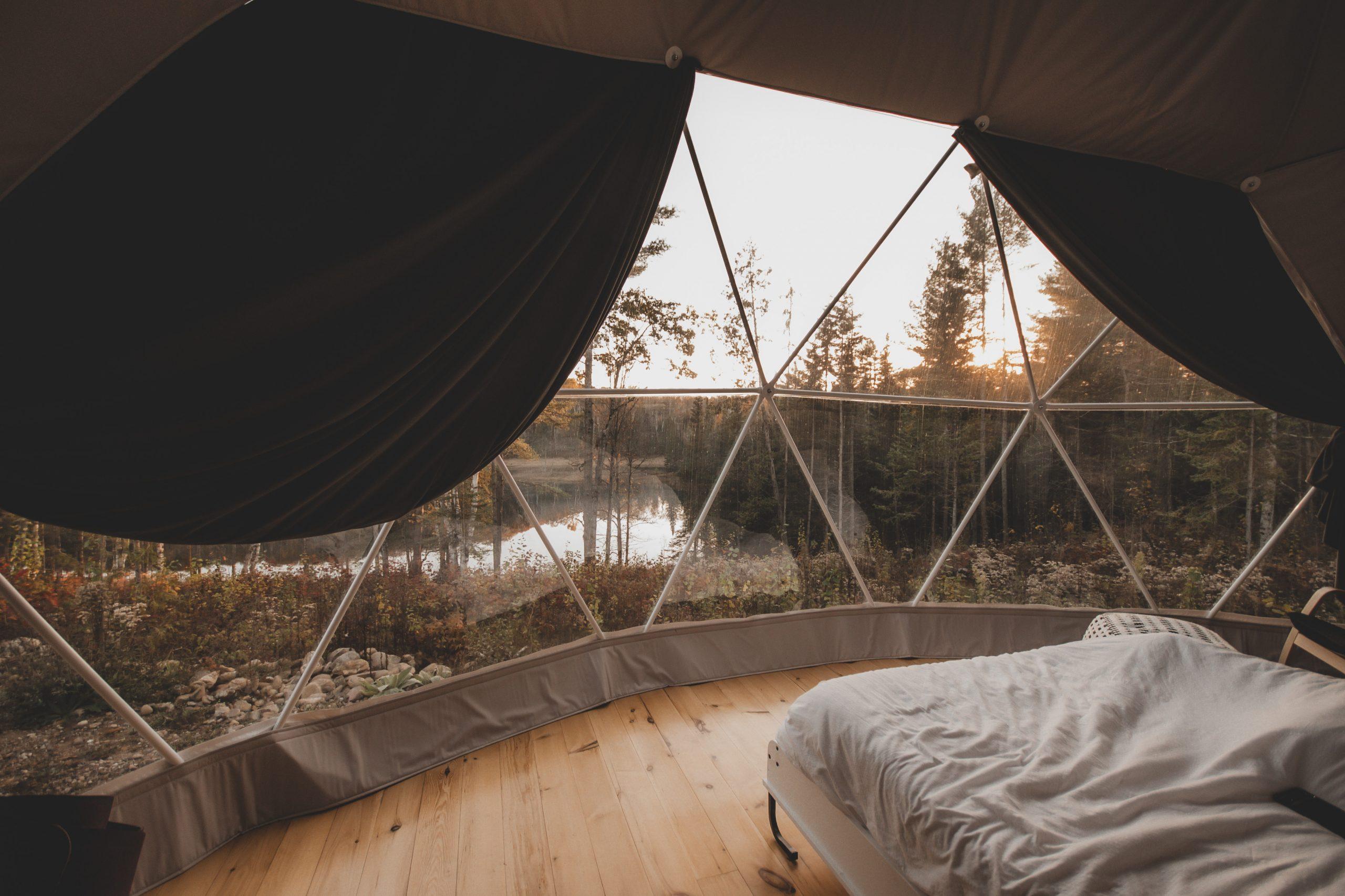 Interior of geodesic dome with view of window and bed