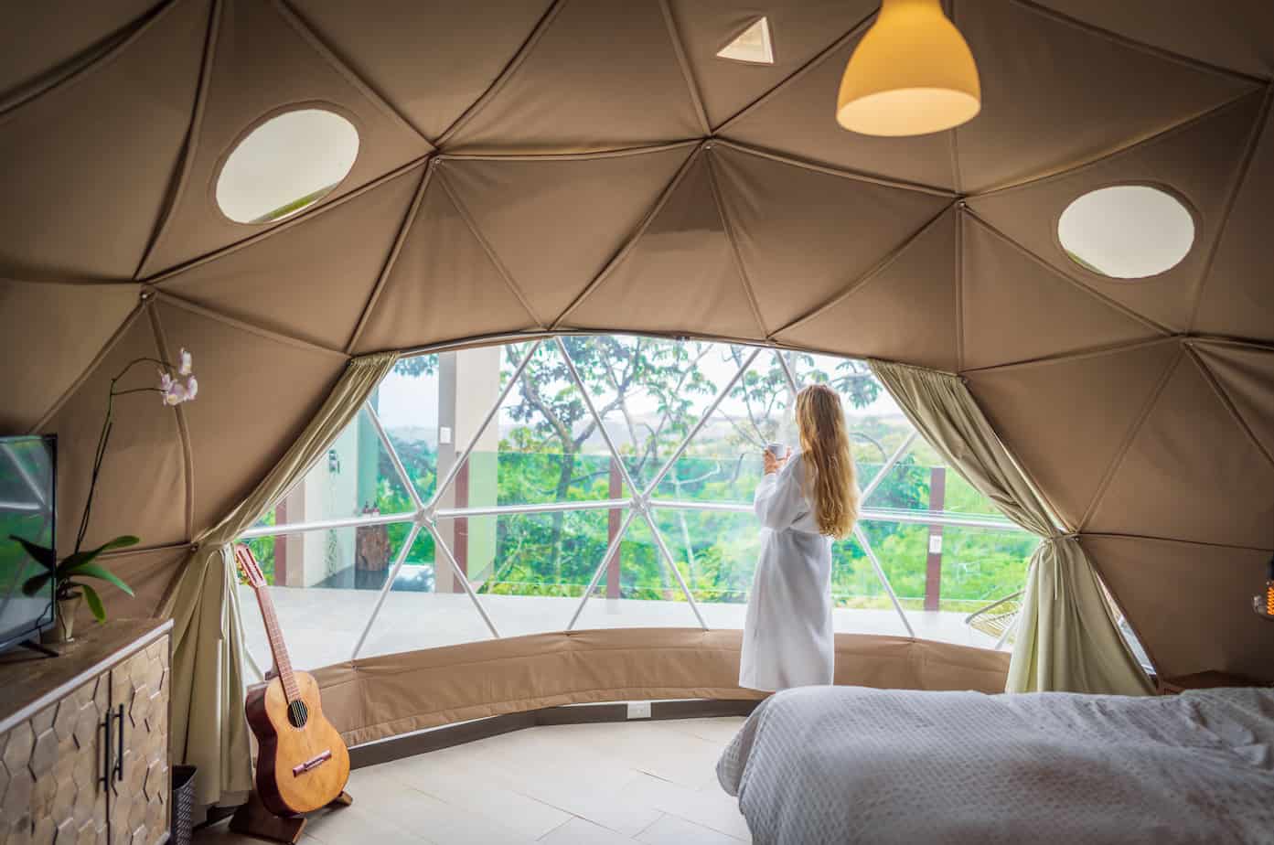 woman in a geodesic dome overlooking the window