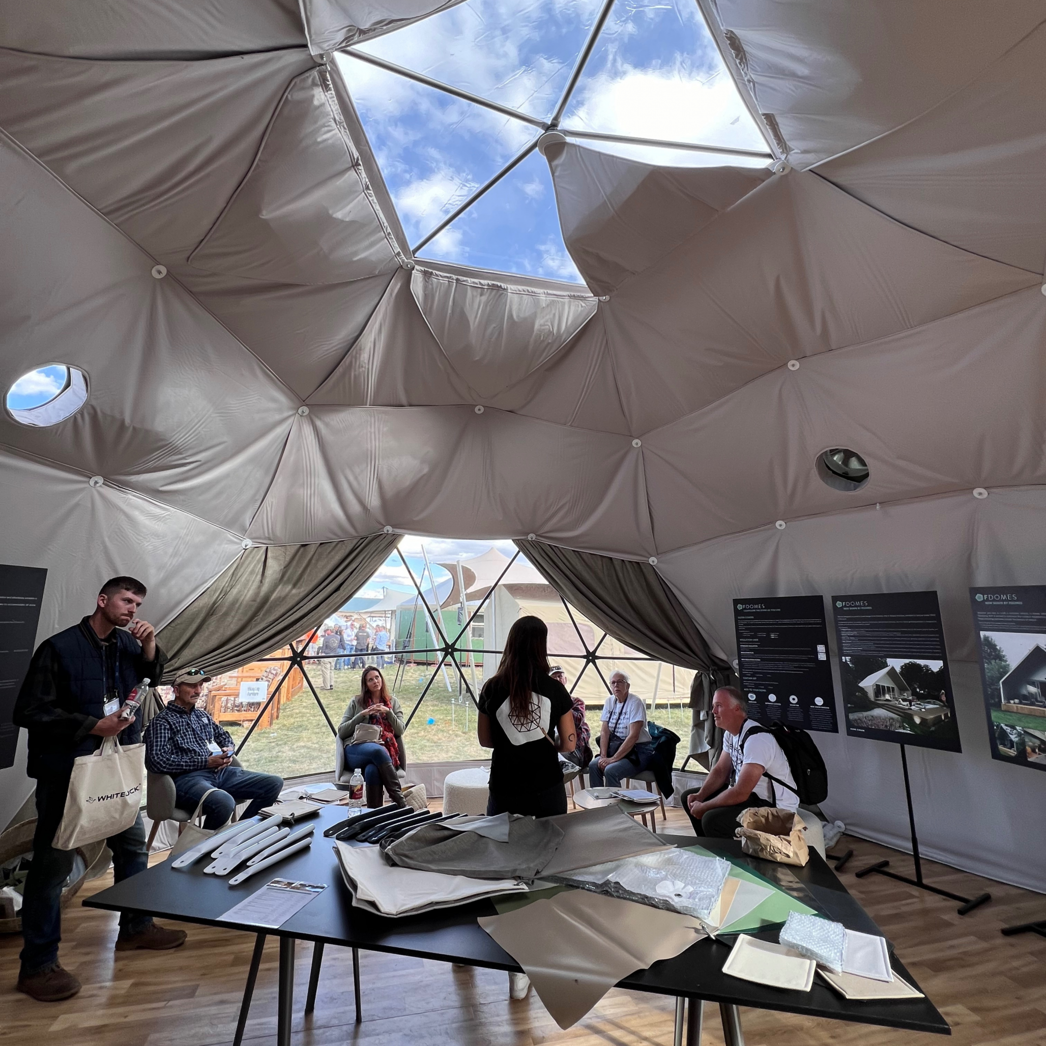 group of people at the glamping geodesic dome by FDomes at Glamping Show Americas 2023, Colorado, USA