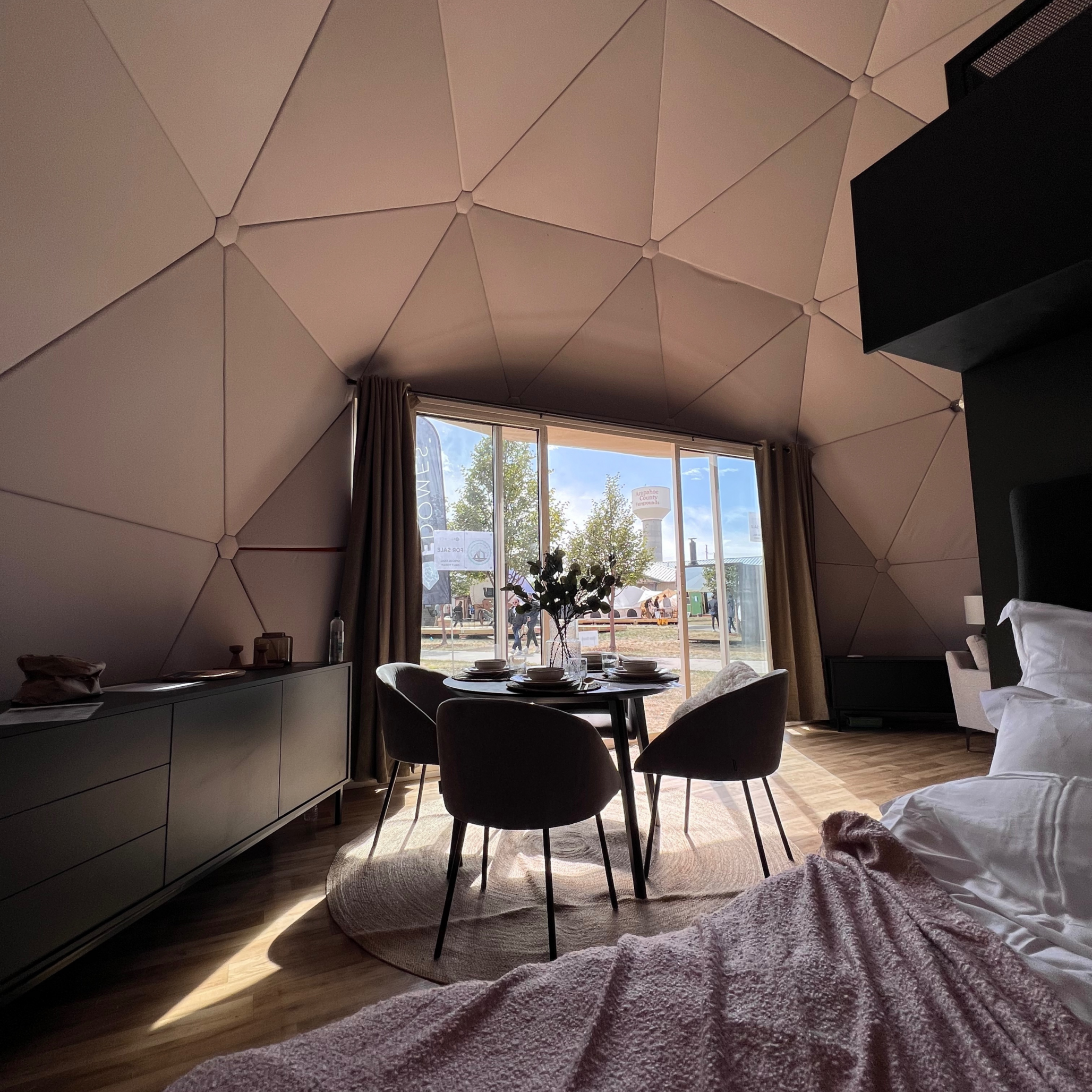 Inside of geodesic glamping dome by FDomes at Glamping Show Americas 2023, Colorado, USA