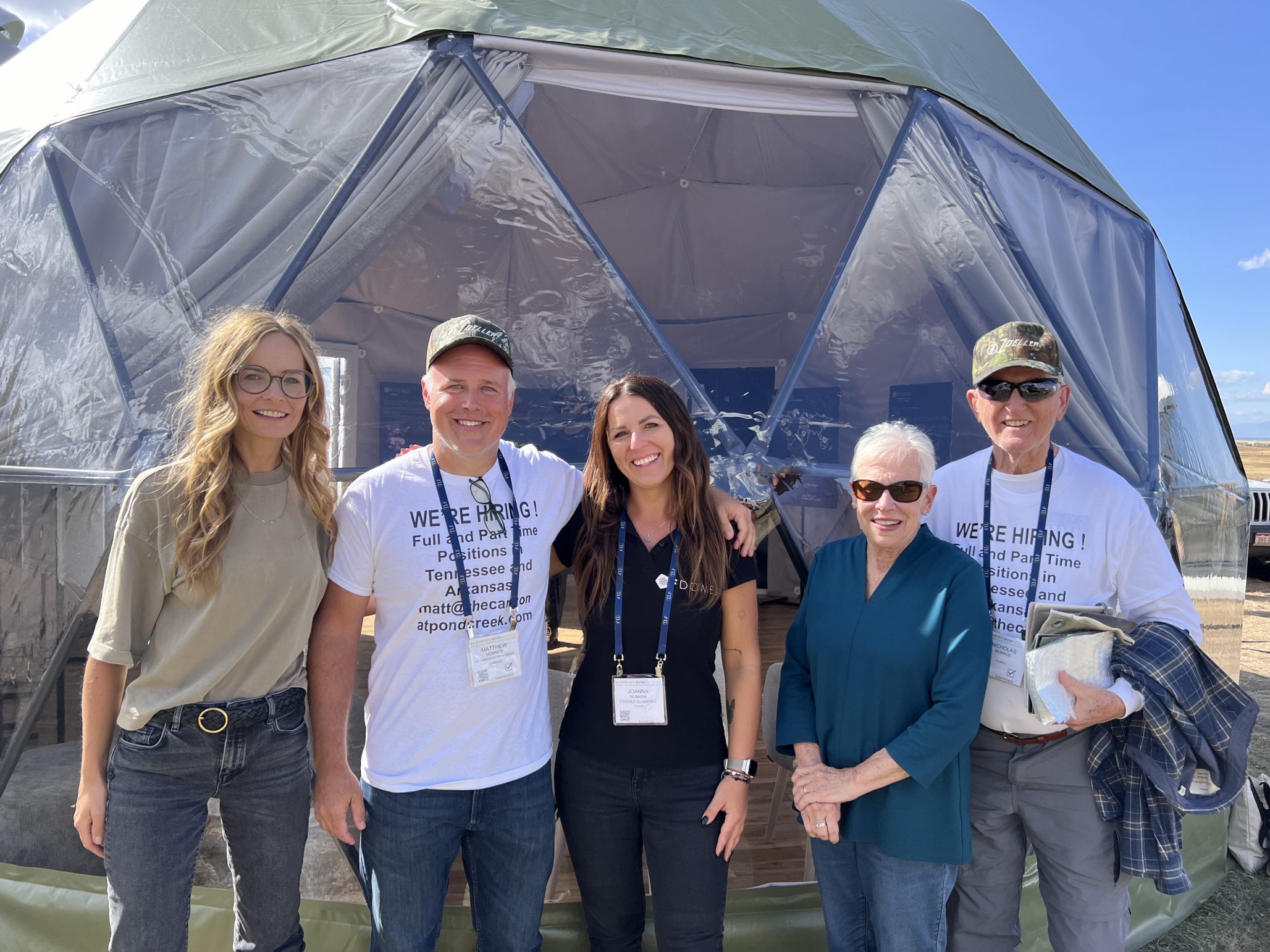 group of people in front of geodesic glamping dome at Glamping Show Americas 2023, Colorado, USA
