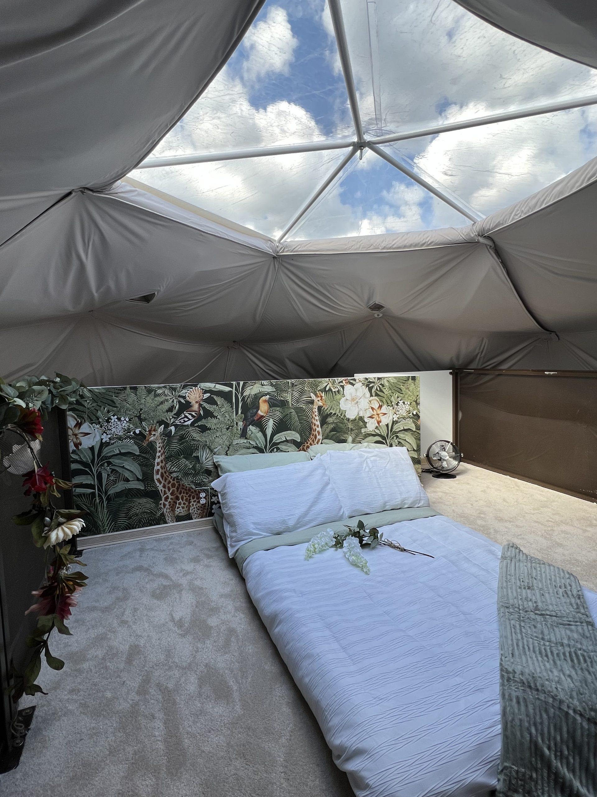 interior of geodesic dome with view at loft bed, insulation and the skylight
