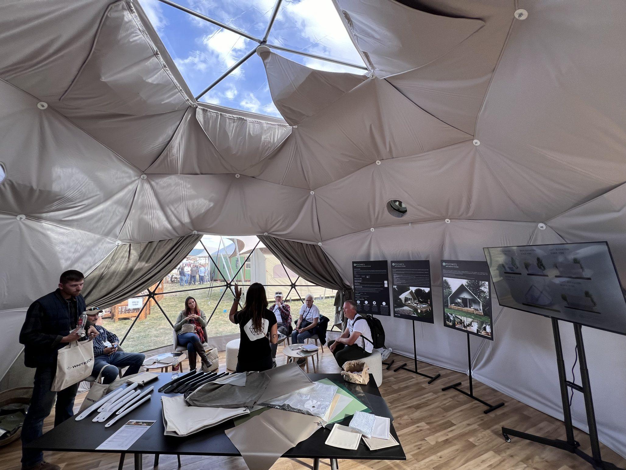 interior of geodesic dome with people while event Glamping Show Americas 2023, Colorado, USA