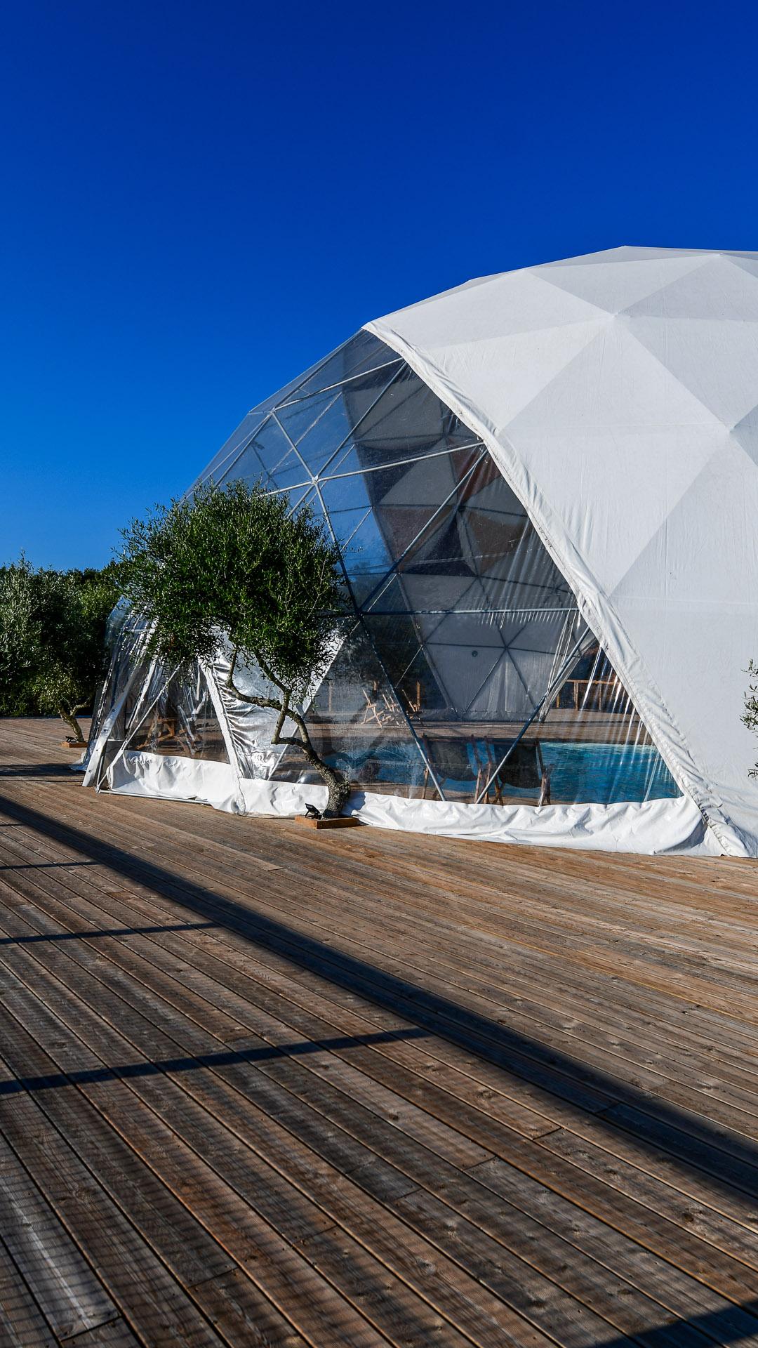 white dome tent with a swimming pool inside